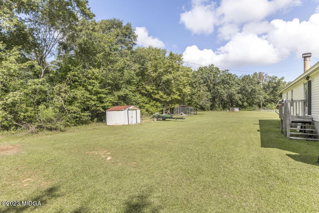 1592 Tribble Road Fort Valley, GA 31030 - Photo 8 of 30 a view of a yard with an outdoor space