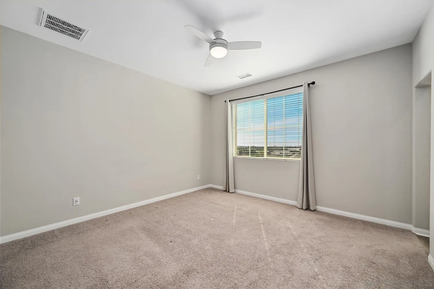 1515 Fig Tree Way Oceanside, CA 92056 - Photo 15 of 27 an empty room with a window and a ceiling fan