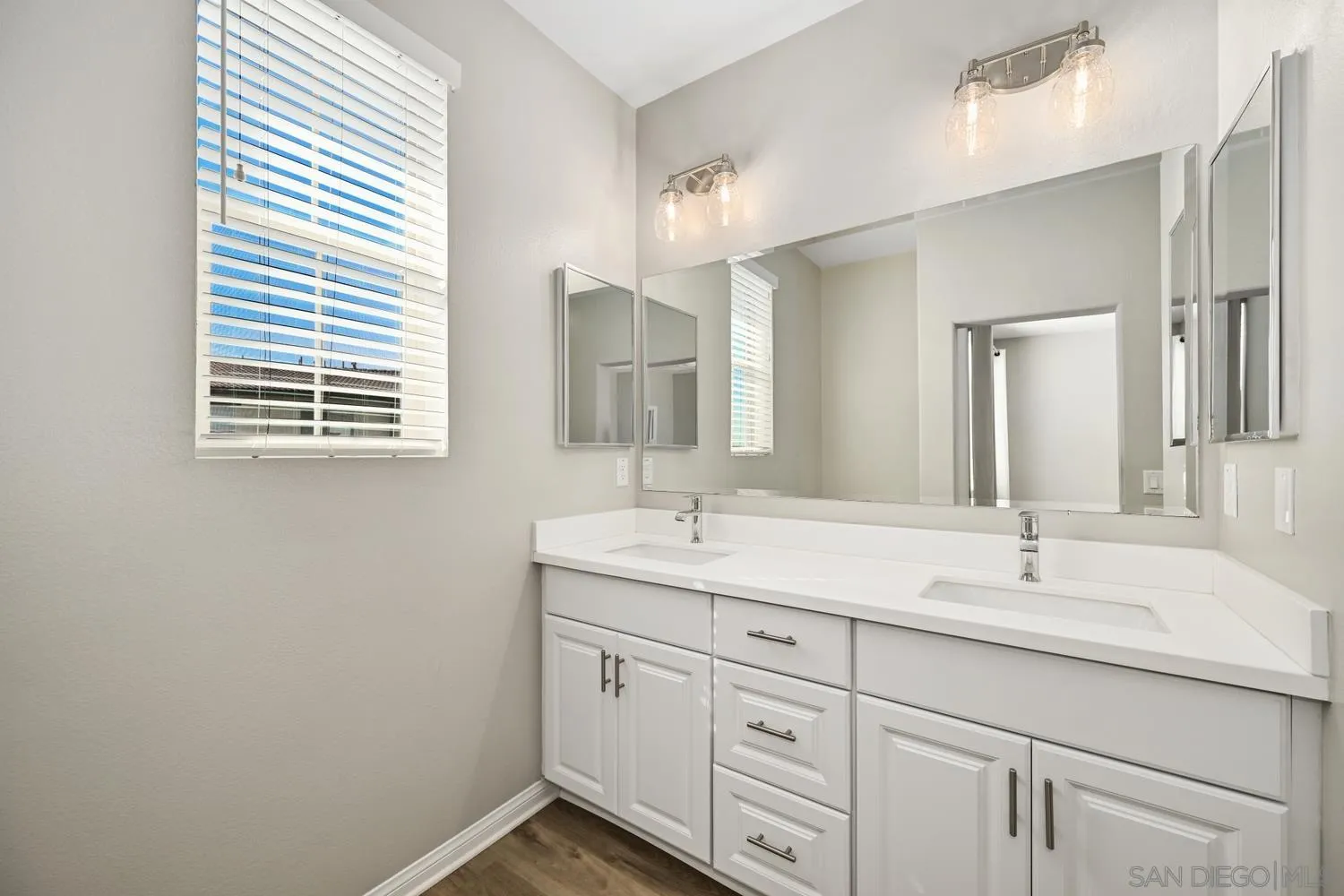 1515 Fig Tree Way Oceanside, CA 92056 - Photo 16 of 27 a bathroom with a sink and a mirror