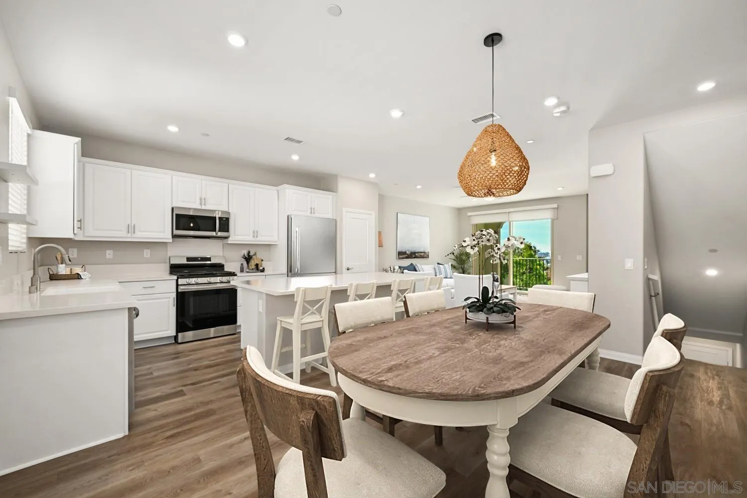 1515 Fig Tree Way Oceanside, CA 92056 - Photo 2 of 27 a kitchen with a table chairs sink and cabinets