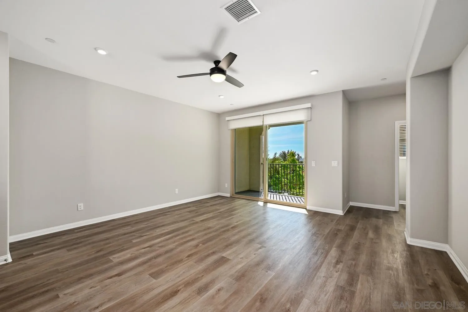 1515 Fig Tree Way Oceanside, CA 92056 - Photo 5 of 27 a view of an empty room with wooden floor and a window