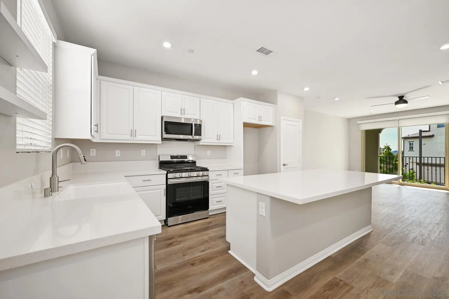 1515 Fig Tree Way Oceanside, CA 92056 - Photo 8 of 27 a kitchen with stainless steel appliances kitchen island sink refrigerator and stove