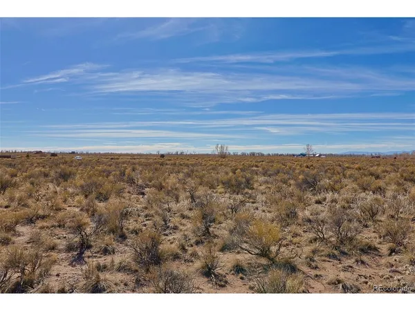 a view of a field with an ocean