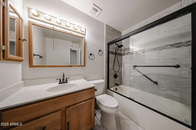 a view of an empty room with a ceiling fan and window