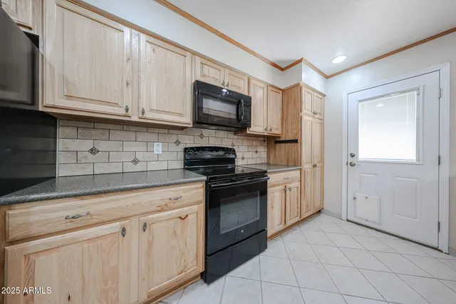 a kitchen with white cabinets stainless steel appliances and sink
