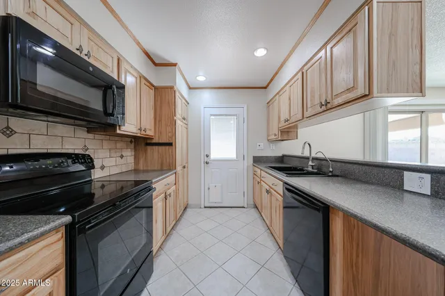 a kitchen with stainless steel appliances granite countertop a sink and a stove