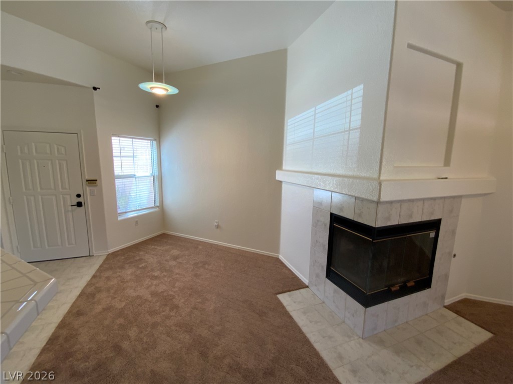 7400 West Flamingo Road, Unit 1039 Las Vegas, NV 89147 - Photo 6 of 40 A corner fireplace creates a cozy ambiance in this inviting room with vaulted ceilings.