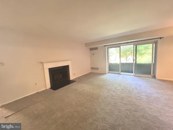 a view of an empty room with a fireplace