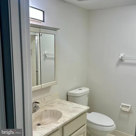 a white toilet sitting next to a bathroom sink