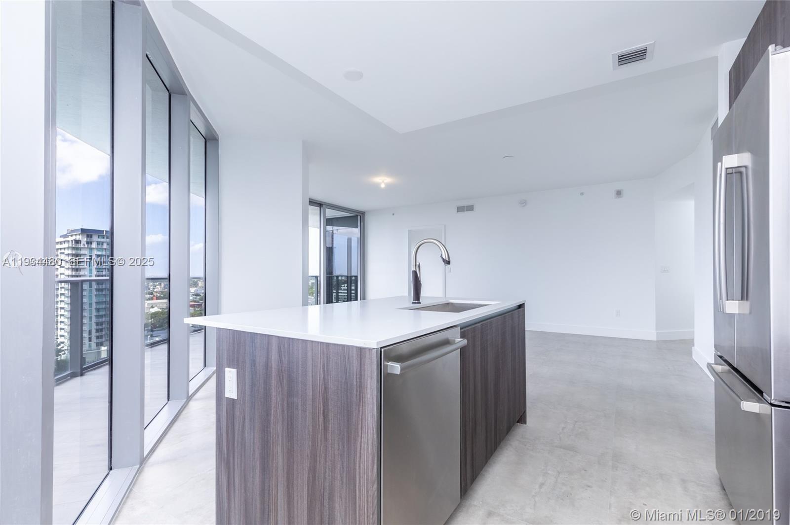 488 Northeast 18th Street, Unit 1600 Miami, FL 33132 - Photo 13 of 34 a kitchen with stainless steel appliances a sink stove and refrigerator