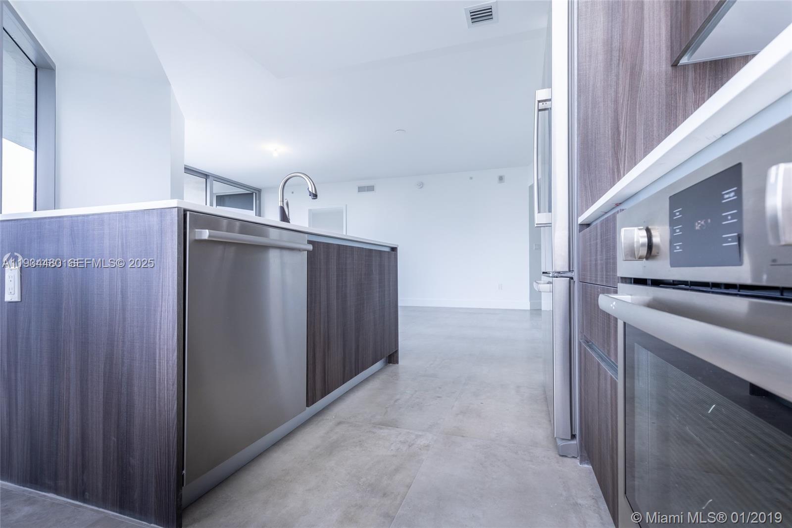 488 Northeast 18th Street, Unit 1600 Miami, FL 33132 - Photo 15 of 34 a kitchen with a sink and a refrigerator
