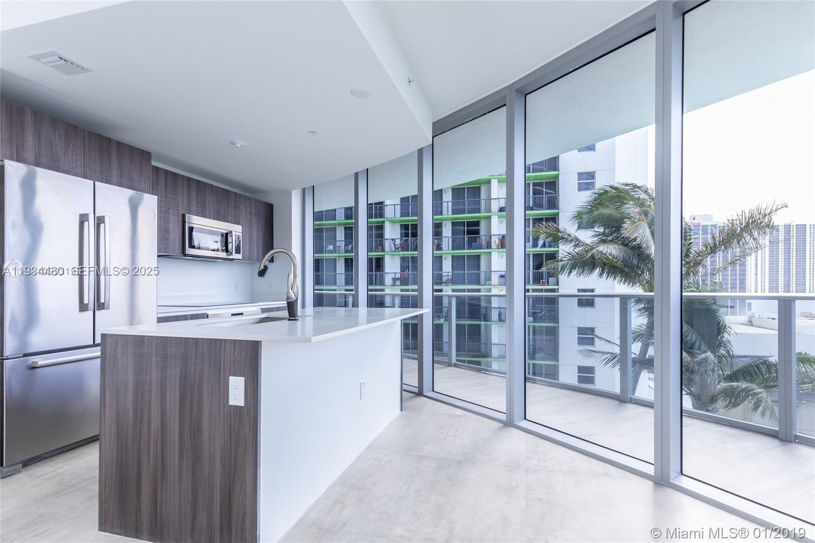 488 Northeast 18th Street, Unit 1600 Miami, FL 33132 - Photo 17 of 34 a kitchen with stainless steel appliances granite countertop a refrigerator and a stove