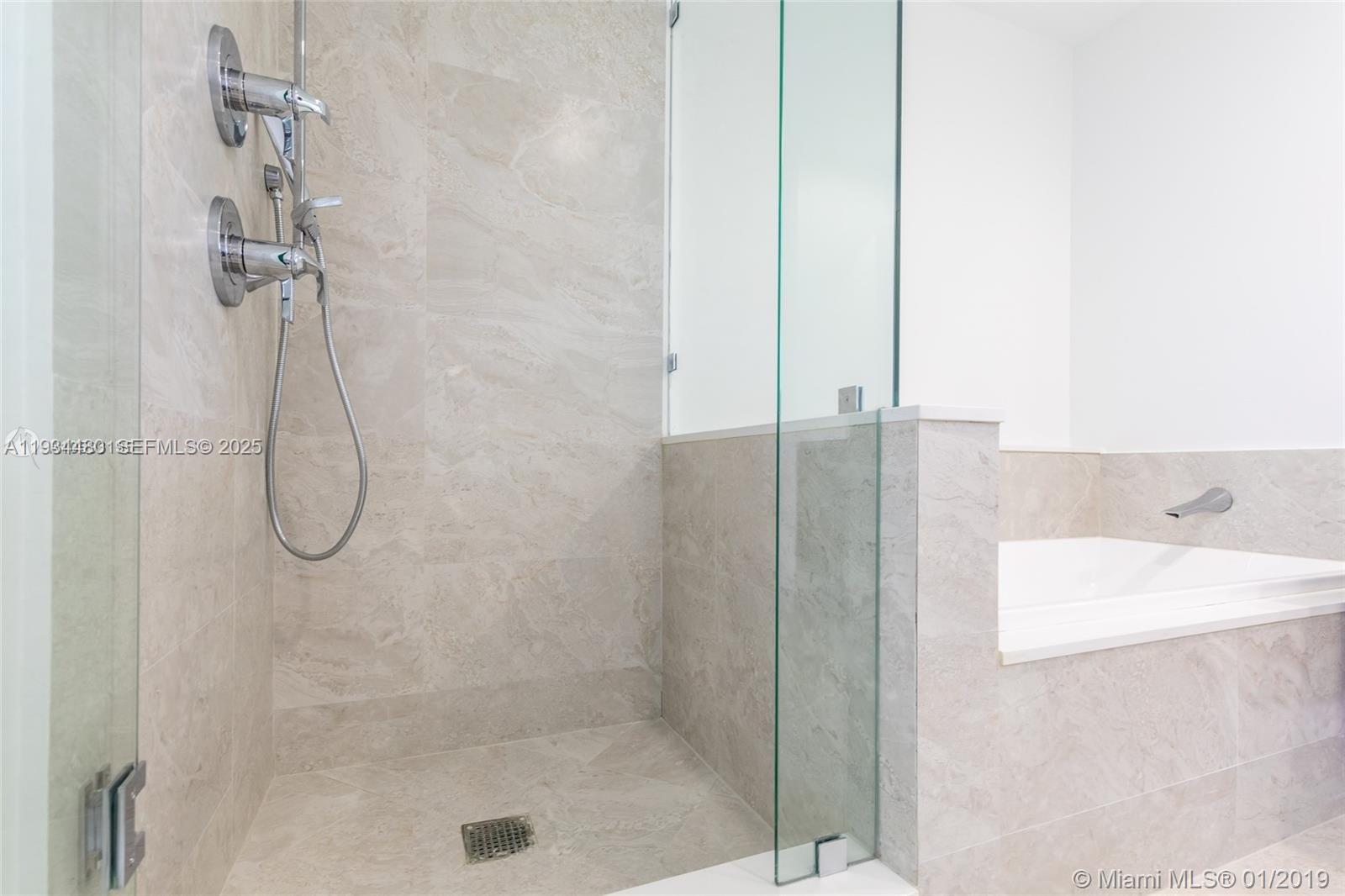 488 Northeast 18th Street, Unit 1600 Miami, FL 33132 - Photo 22 of 34 a bathroom with a bath tub