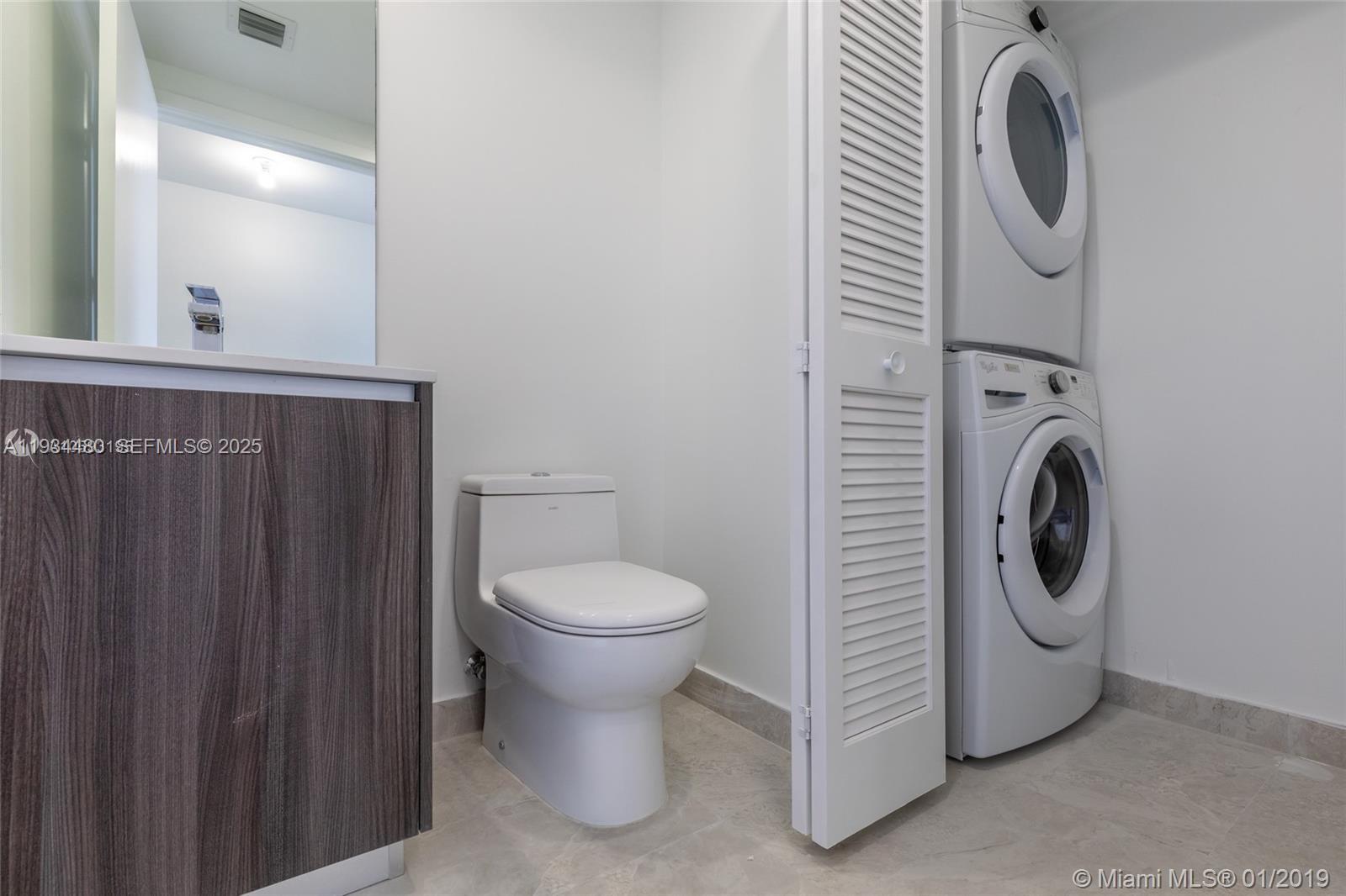 488 Northeast 18th Street, Unit 1600 Miami, FL 33132 - Photo 26 of 34 a utility room with dryer and washer
