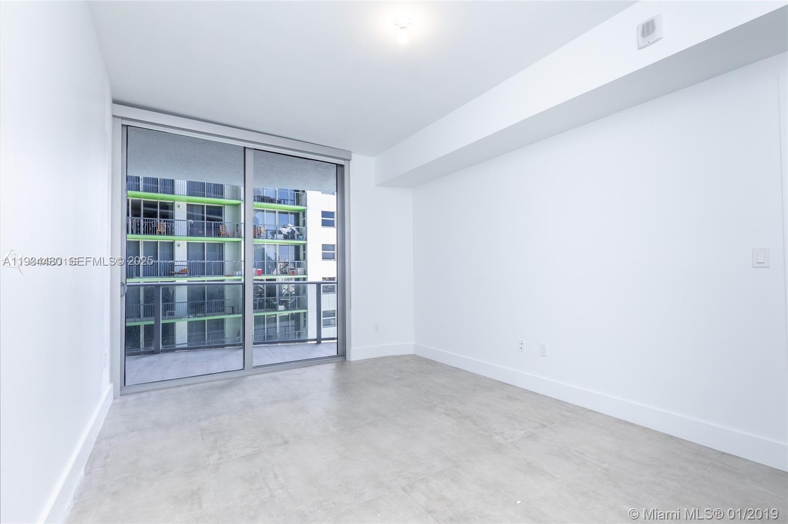 488 Northeast 18th Street, Unit 1600 Miami, FL 33132 - Photo 28 of 34 a view of an empty room with a window