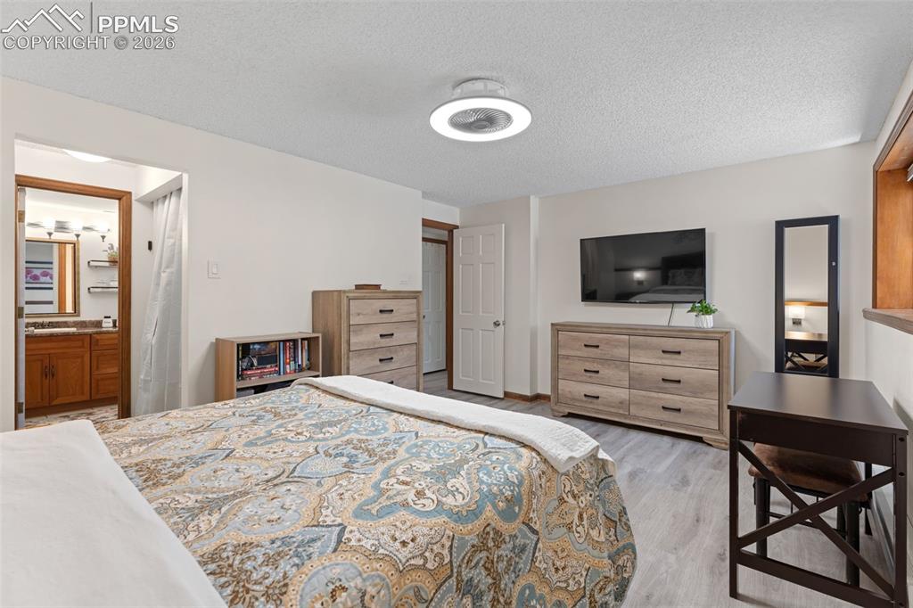 1851 Buttercup Road Elizabeth, CO 80107 - Photo 26 of 47 a bedroom with a bed and a flat screen tv in it