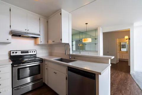 a kitchen with a sink and a refrigerator