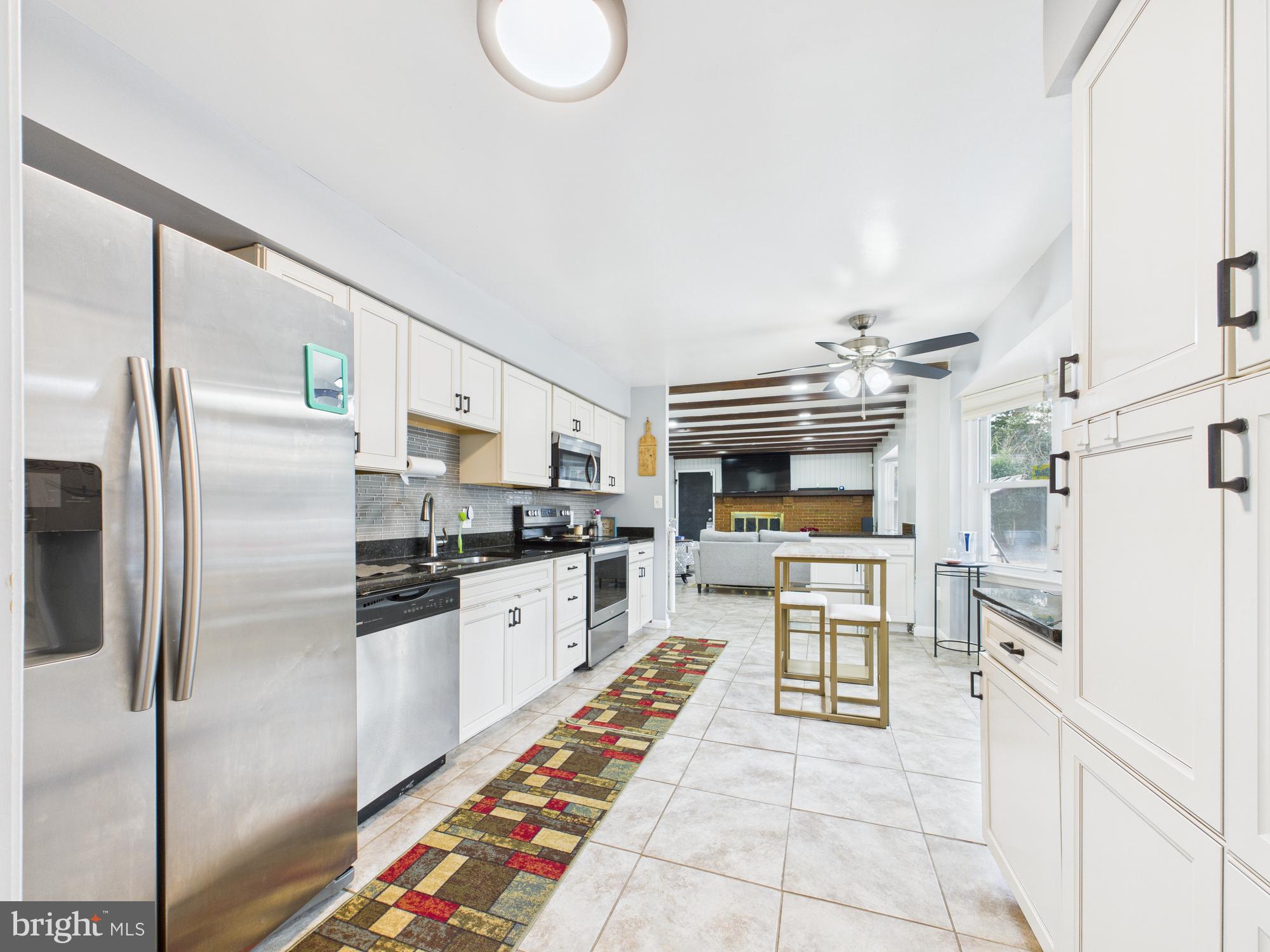 14212 Notley Road Silver Spring, MD 20904 - Photo 17 of 43 a kitchen with stainless steel appliances granite countertop a refrigerator a stove and a sink