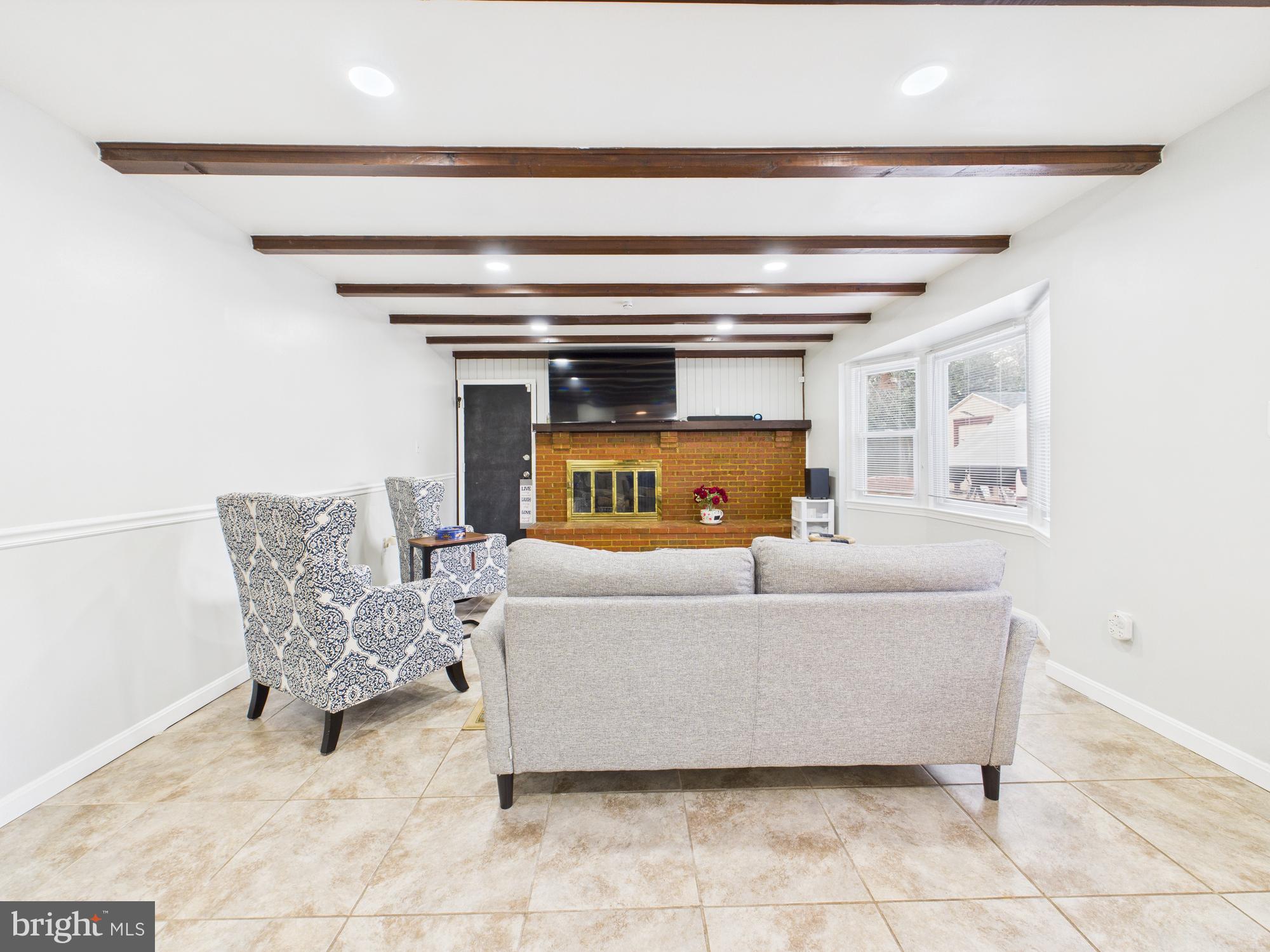 14212 Notley Road Silver Spring, MD 20904 - Photo 18 of 43 a living room with a couch and a table