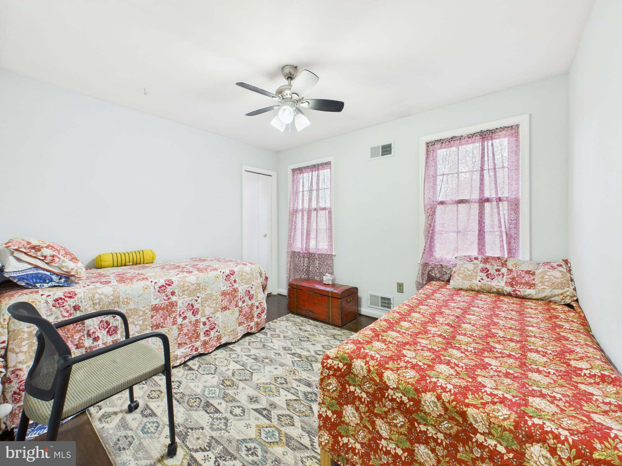 14212 Notley Road Silver Spring, MD 20904 - Photo 32 of 43 a bedroom with a bed and wooden floor