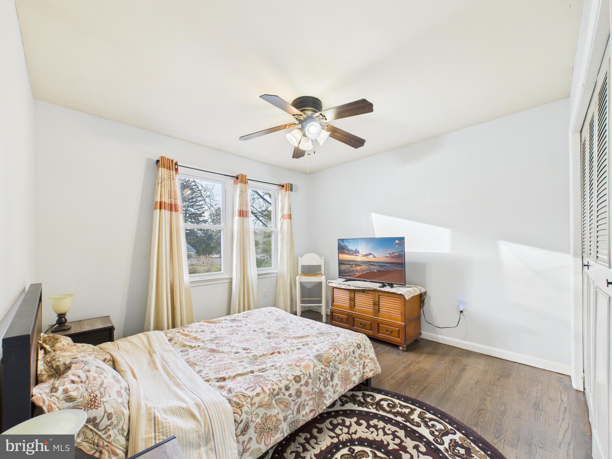 14212 Notley Road Silver Spring, MD 20904 - Photo 33 of 43 a bedroom with a bed and wooden floor