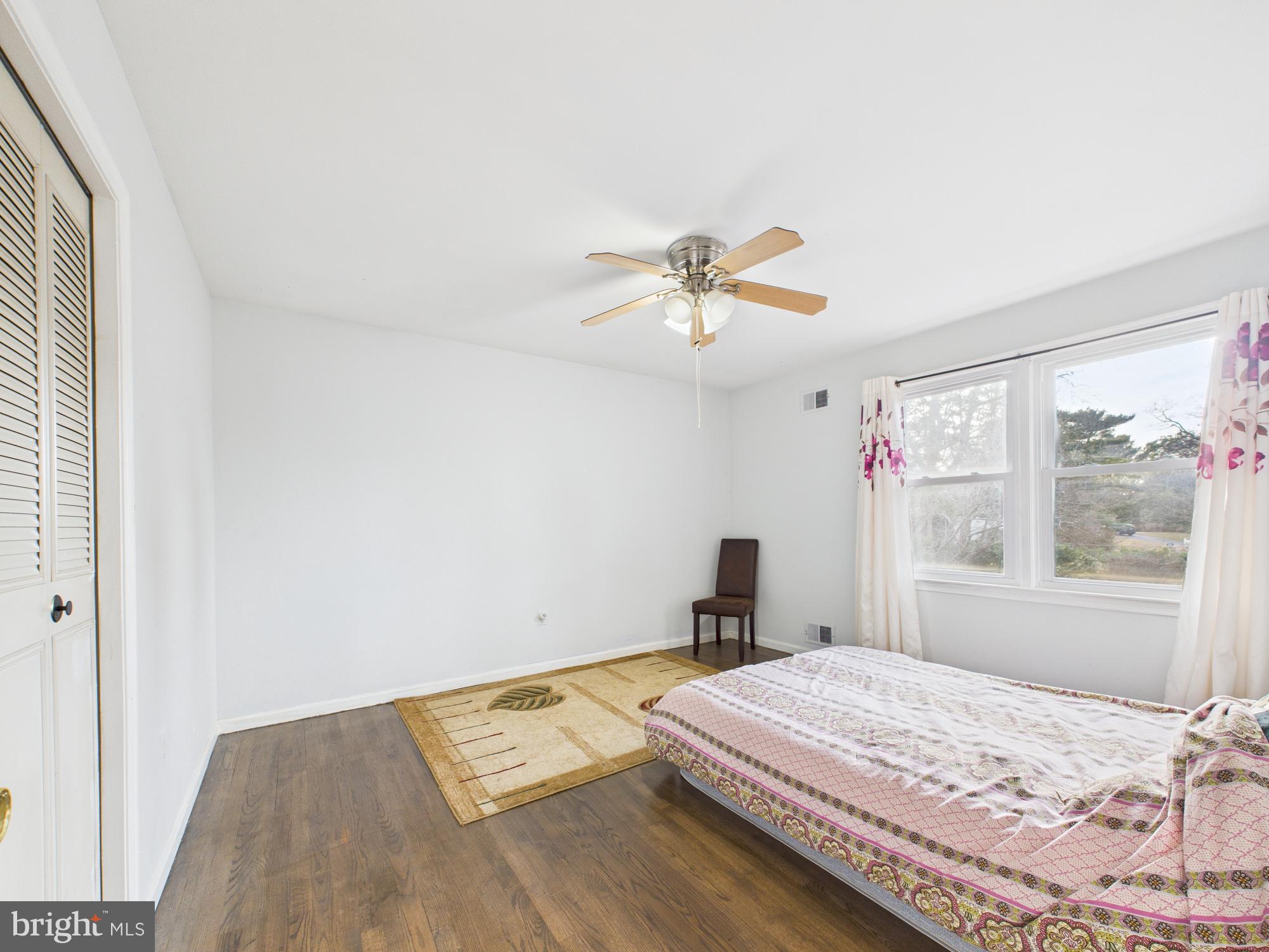14212 Notley Road Silver Spring, MD 20904 - Photo 34 of 43 a bedroom with a bed and a chandelier