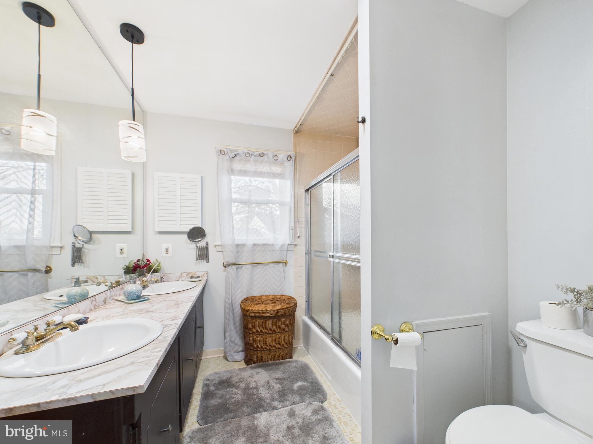 14212 Notley Road Silver Spring, MD 20904 - Photo 35 of 43 a bathroom with a sink toilet and shower