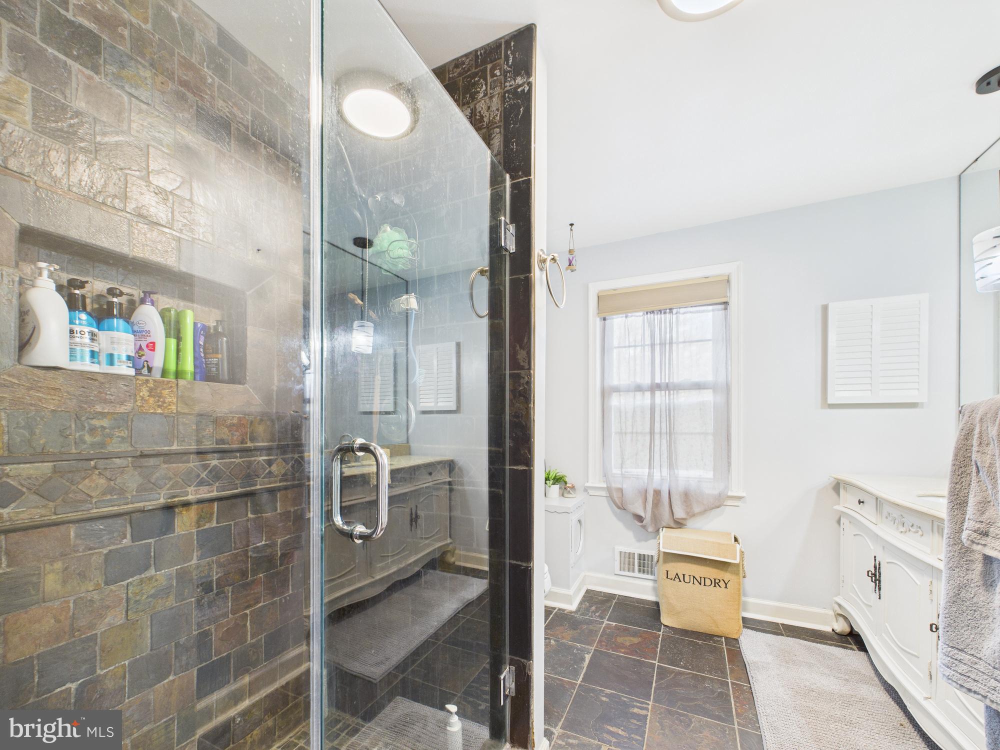 14212 Notley Road Silver Spring, MD 20904 - Photo 37 of 43 a bathroom with a glass shower door and a sink