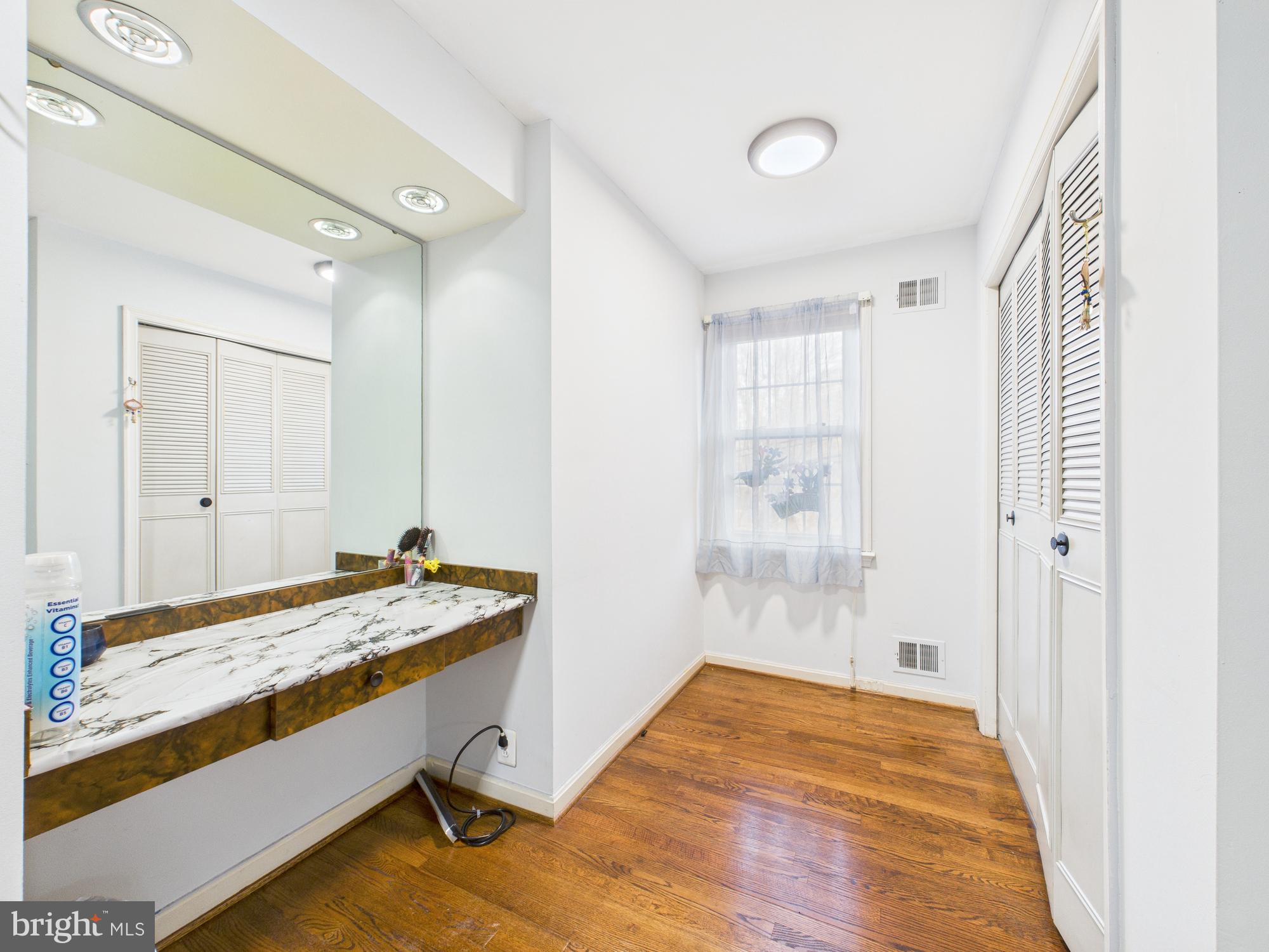 14212 Notley Road Silver Spring, MD 20904 - Photo 40 of 43 a bathroom with a granite countertop sink and a mirror