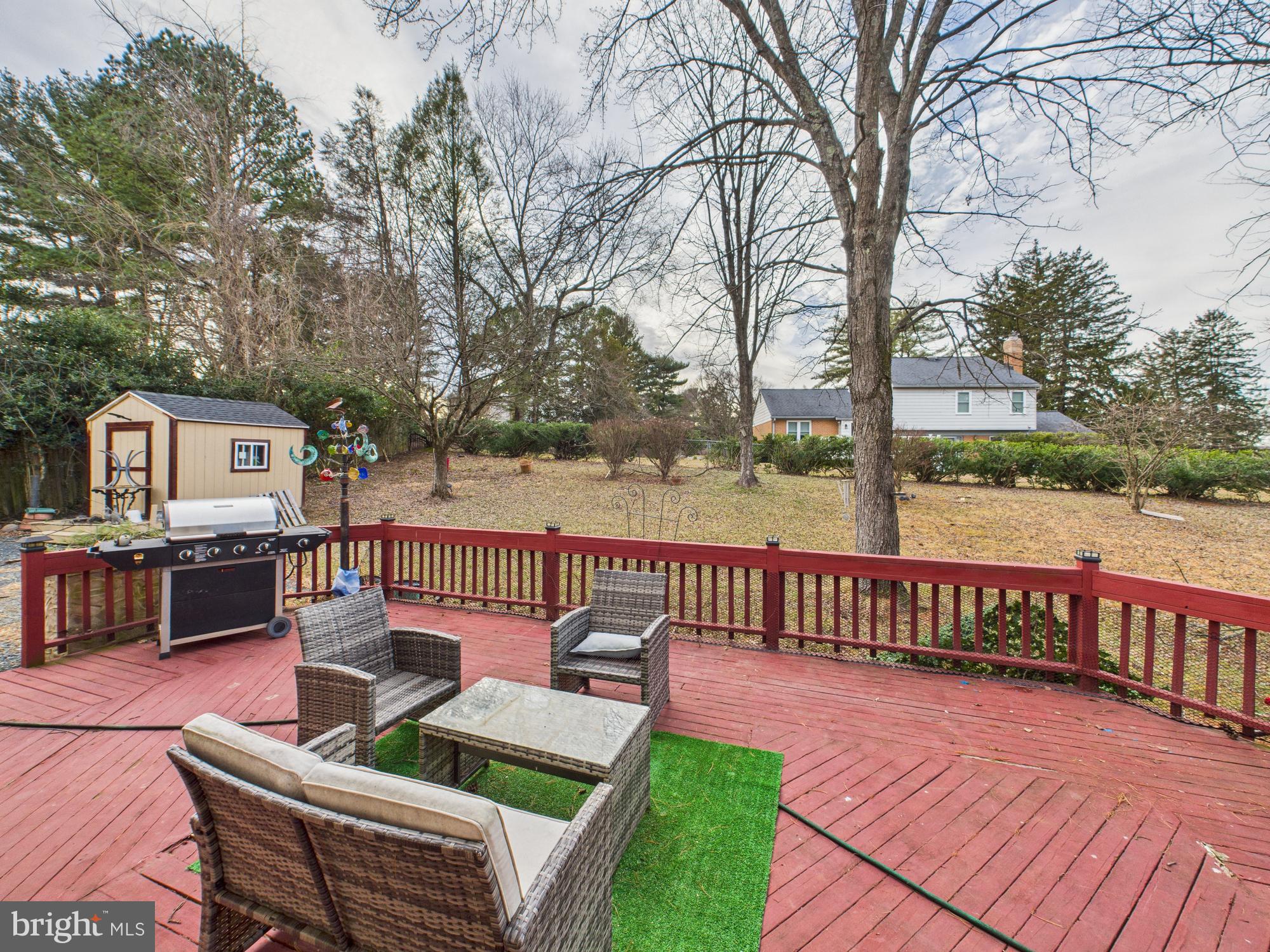 14212 Notley Road Silver Spring, MD 20904 - Photo 8 of 43 a view of a patio with couches table and chairs and wooden floor