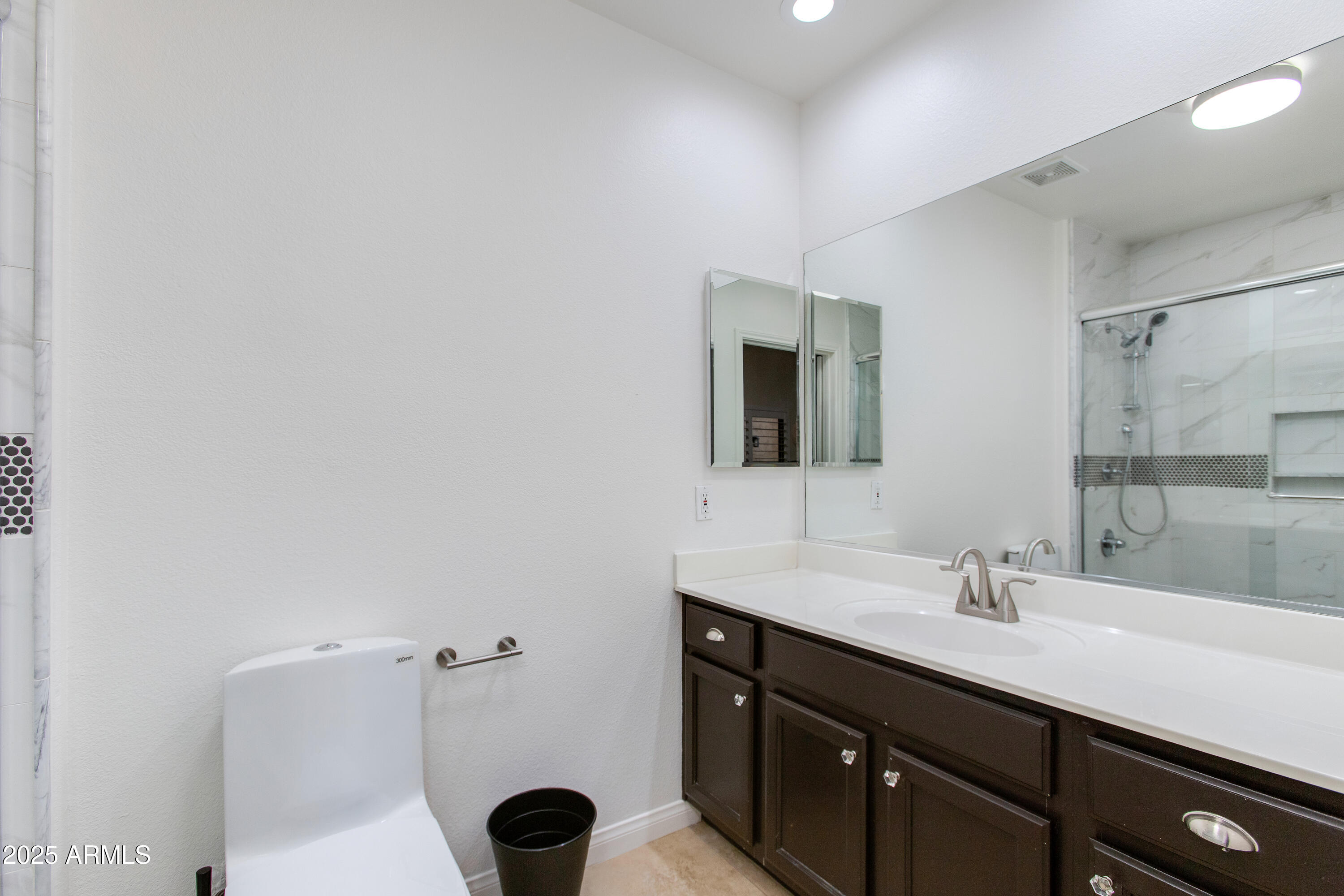 8245 East Bell Road, Unit 102 Scottsdale, AZ 85260 - Photo 14 of 21 a bathroom with a sink and a mirror