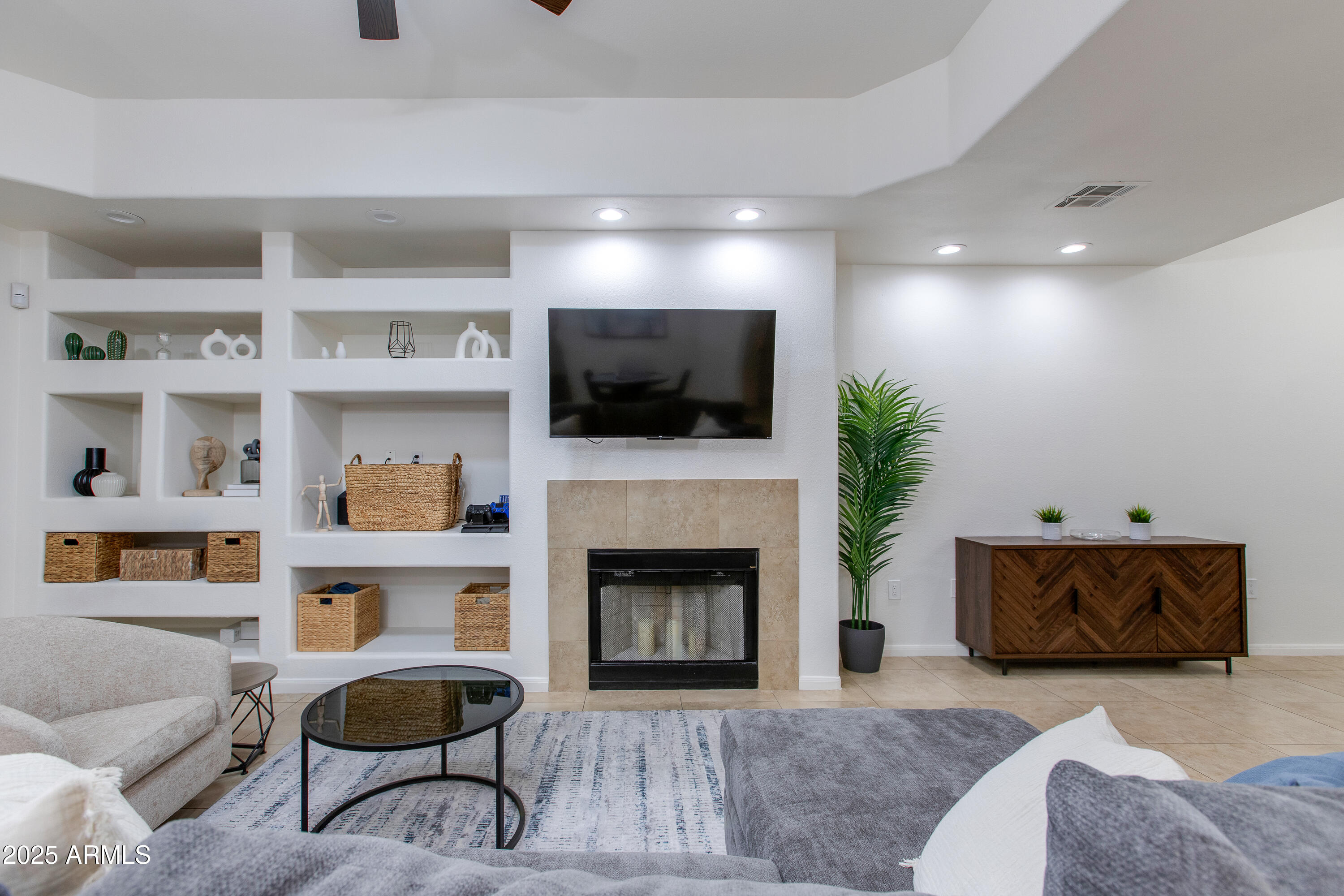 8245 East Bell Road, Unit 102 Scottsdale, AZ 85260 - Photo 4 of 21 a living room with furniture and a fireplace