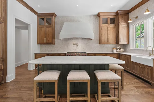 a bathroom with a granite countertop sink a mirror and a shower