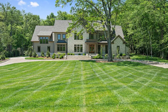 a front view of a house with a yard