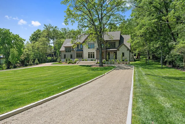a view of a house with a balcony and large windows