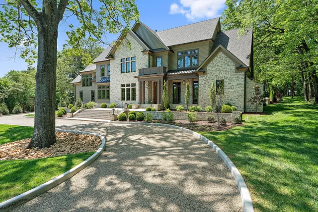 a view of a hallway with wooden floor and a bathroom