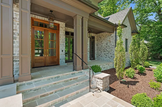a living room with furniture a chandelier and a fireplace