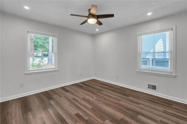 a bathroom with a granite countertop sink mirror toilet and bathtub