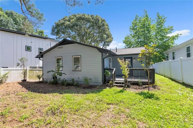 a view of a house with backyard and sitting area
