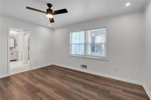 a bathroom with a double vanity sink a toilet a shower and a mirror