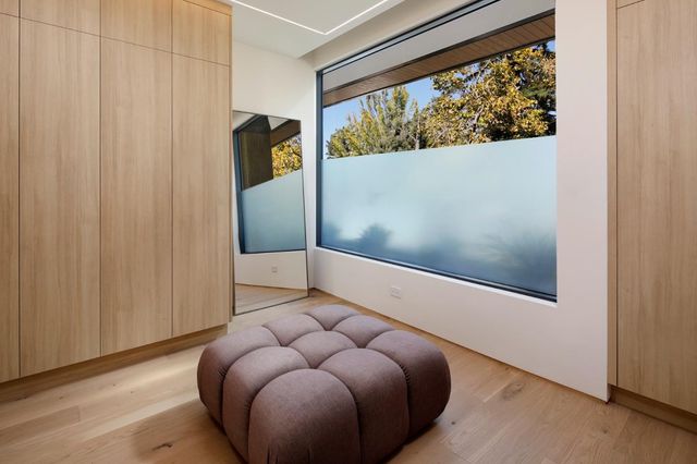 a bedroom with a bed and a curtain with wooden floor
