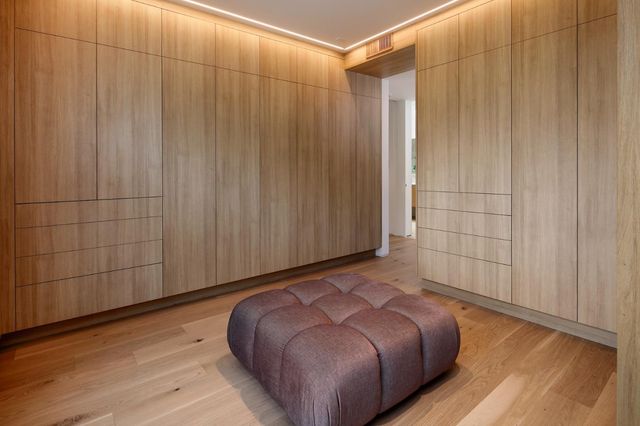 a bed room with a bed and a chair