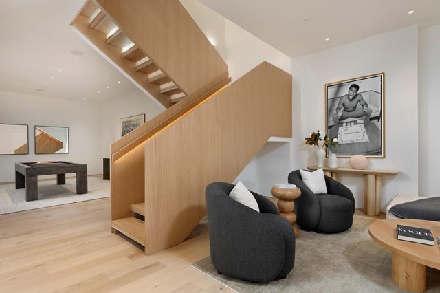 a living room with furniture a pool table and a flat screen tv