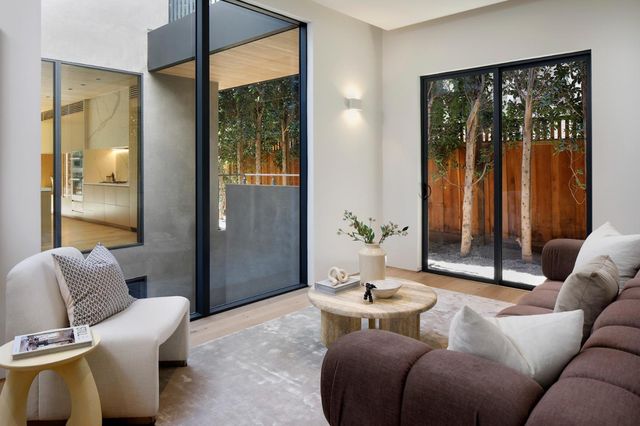 a bedroom with a bed a mirror and a window