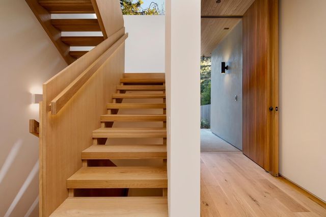 a view of entryway and hall with wooden floor