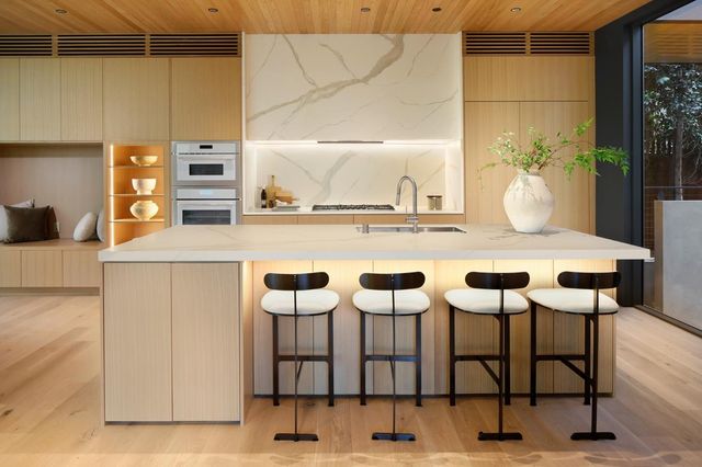 a view of kitchen island with granite countertop cabinets
