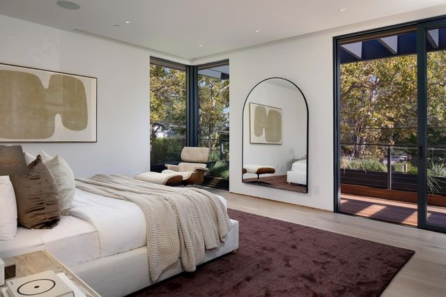 a bedroom with a bed and a large window