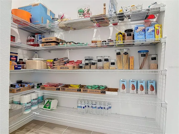 a cabinet with granite countertop lots of different kinds of food