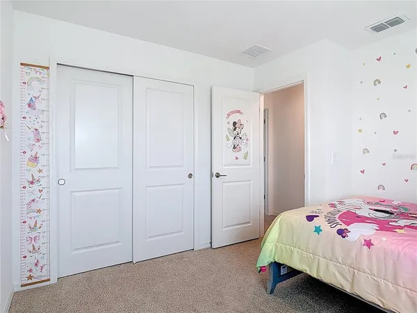 a bedroom with a bed lamp and window