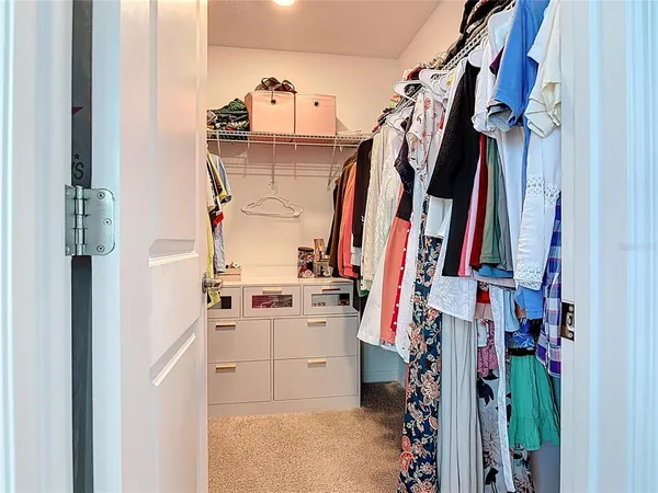 a living room with furniture and a baby crib